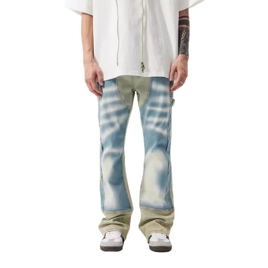 Men's yellow and blue patchwork jeans with a retro splash-ink damaged design on the legs.