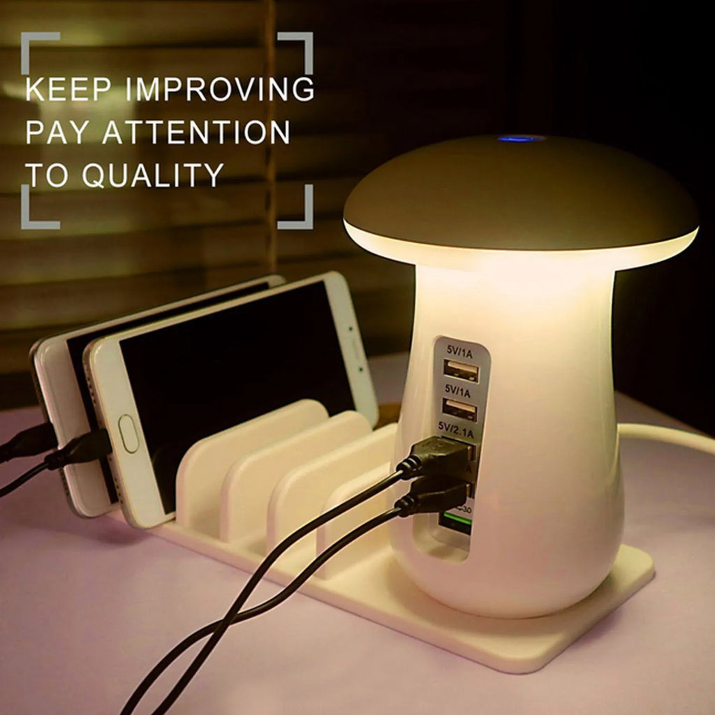White mushroom-shaped LED desk lamp with a 5-port USB charging station at its base on a wooden table.