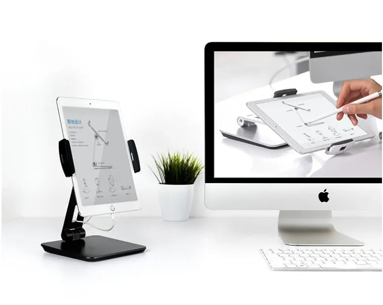 Black foldable aluminium phone and tablet stand with 360-degree rotation on a wooden desk