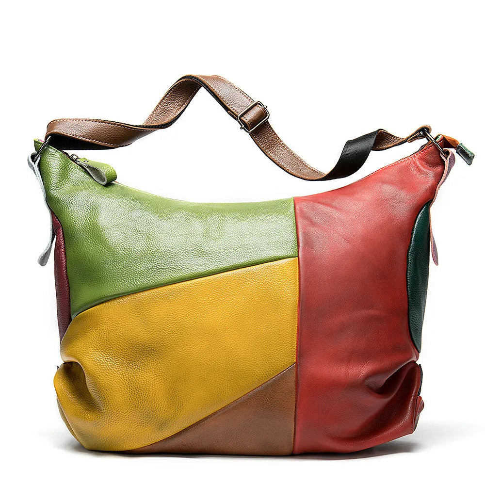 Brown cowhide leather travel bag with stitching detail, shown as a crossbody bag.