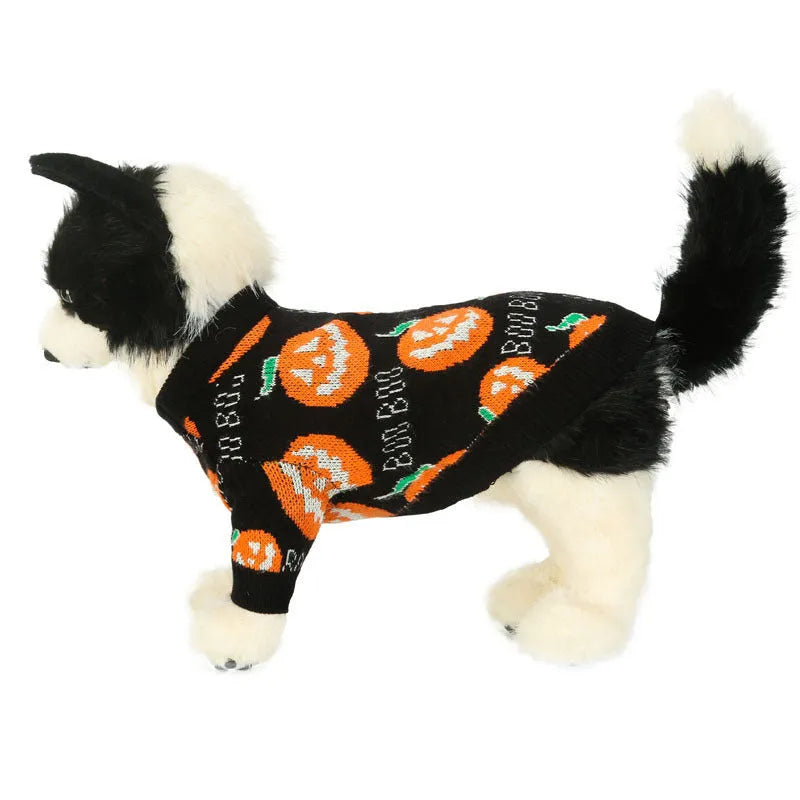 Black dog sweater with an orange Halloween pumpkin print on the back.