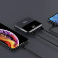 Black 10000mAh portable power bank with digital display showing battery percentage and dual USB ports.