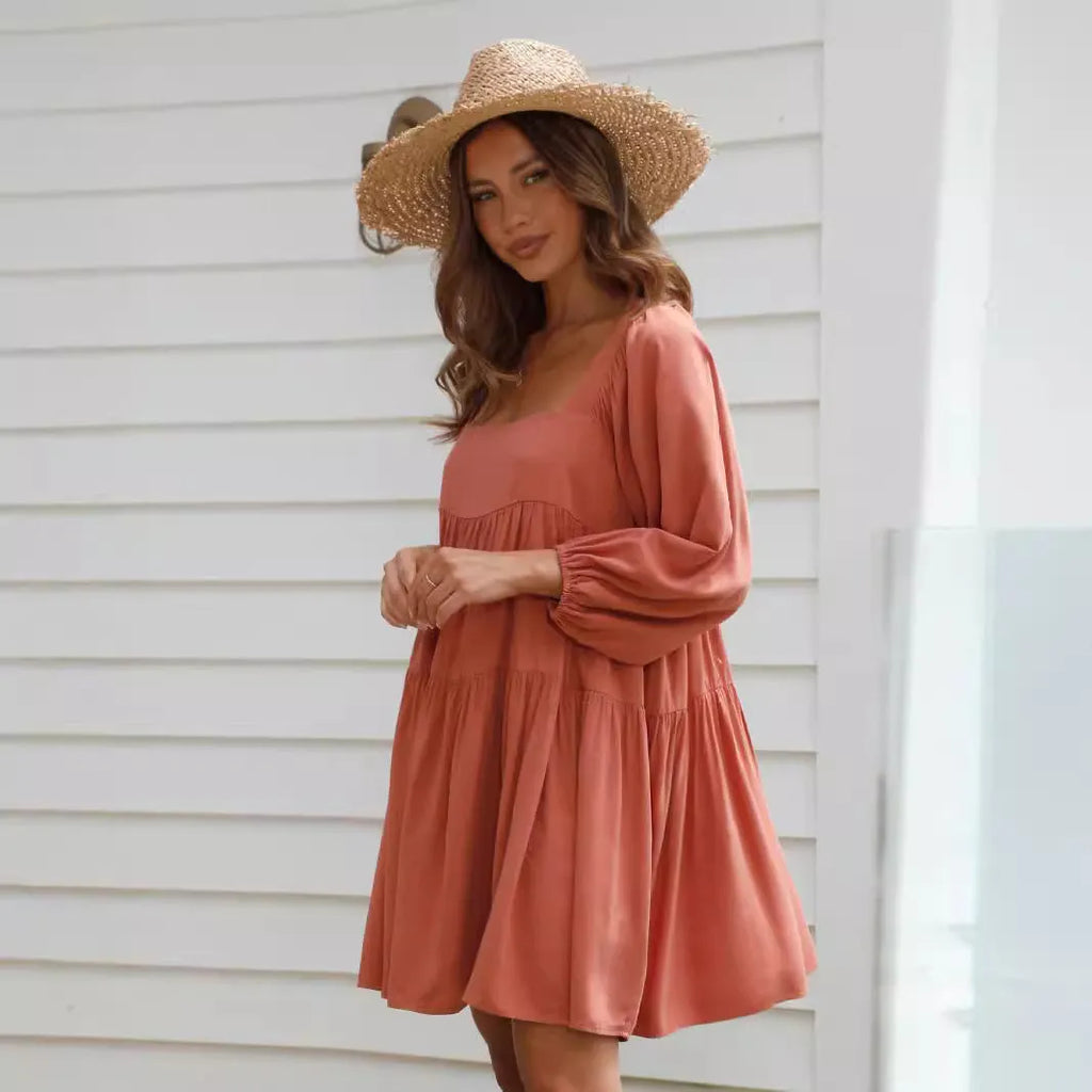 Orange children's dress with puff sleeves, square collar, backless design, and A-line skirt