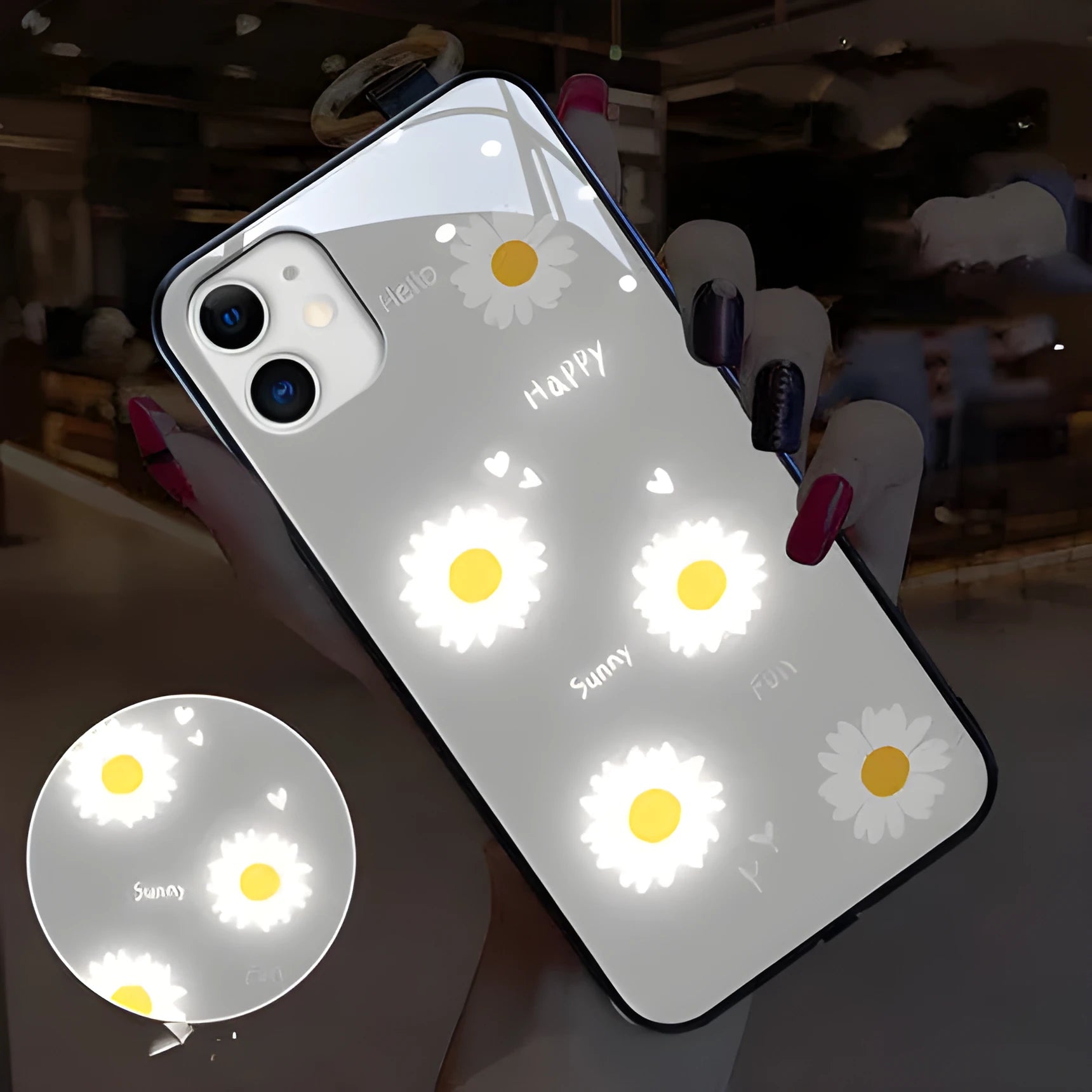 White and purple luminous iPhone cases with painted daisies and voice-activated colour lights on a table.