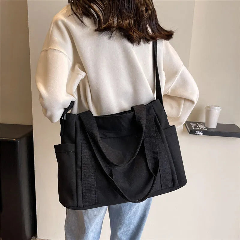 Large solid colour polyester canvas shoulder tote bag for women with internal mobile phone pocket.
