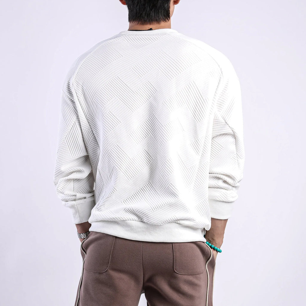 Man wearing a loose fit Army Green twill jacquard long sleeve pullover sweater.