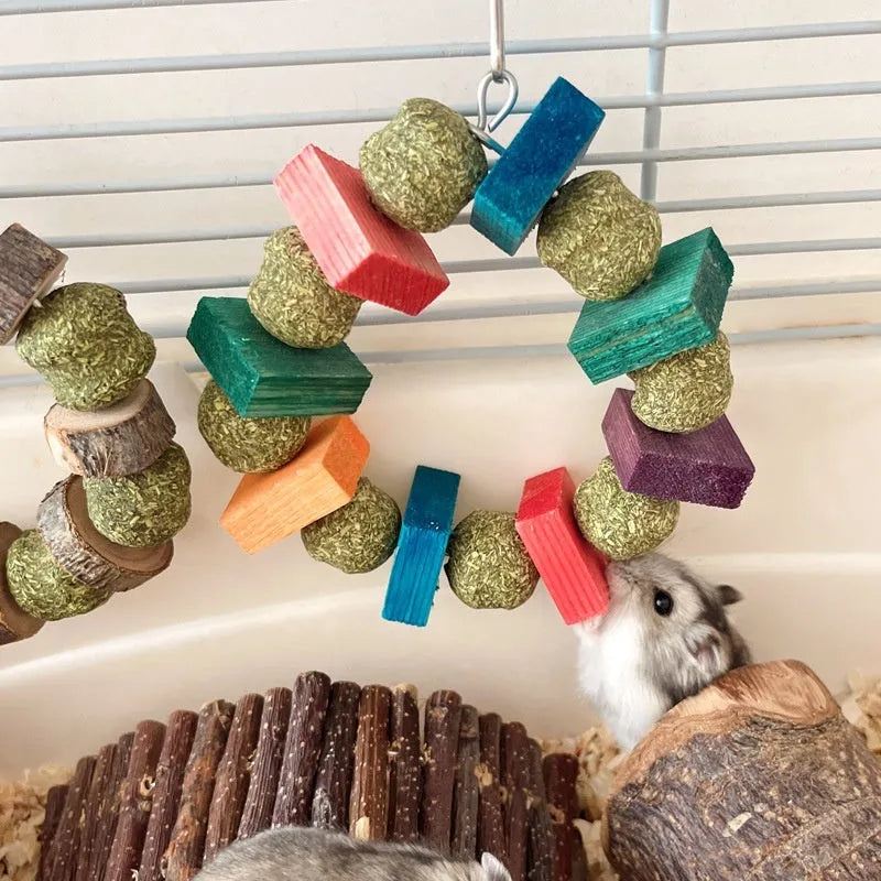 Hamster toy with applewood chew rod and decorative straw ball rings for small animal enrichment
