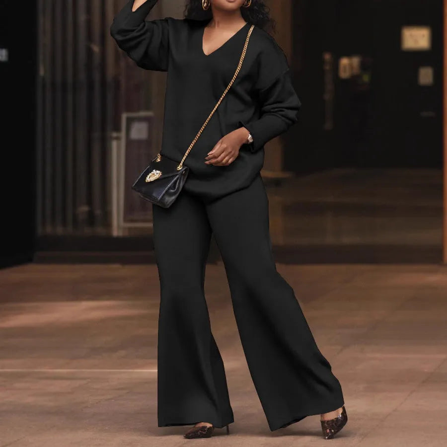 Women's brown suede two-piece suit with long sleeves and trousers on a hanger