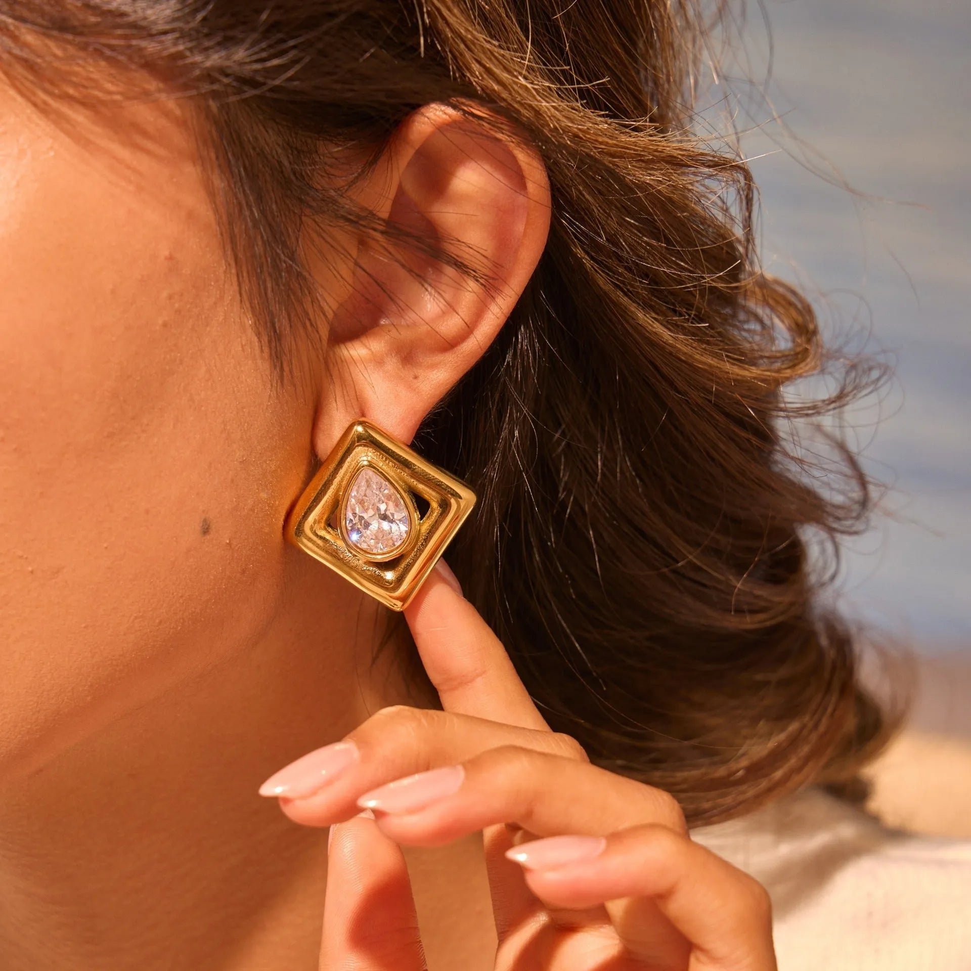 Gold electroplated stud earrings with geometric water drop zircon stone patterns