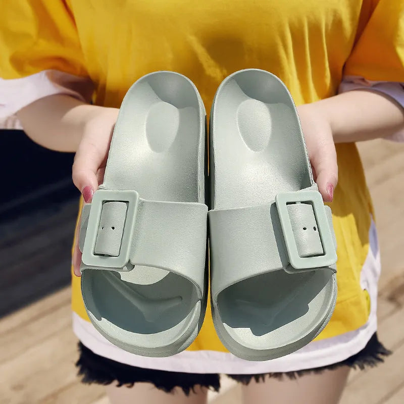 Women's grey blue buckle closure slipper sandals with soft EVA sole on a plain background.