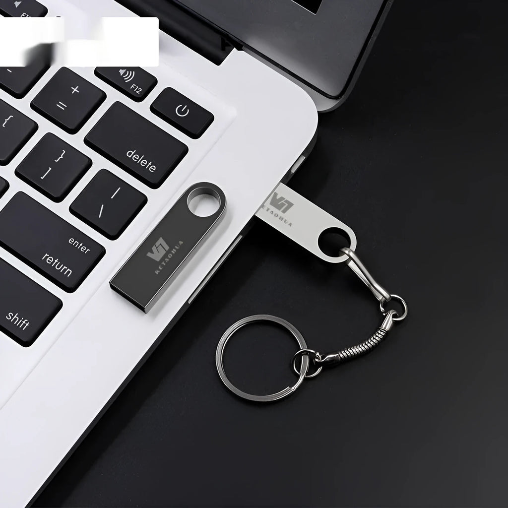 Metal car-shaped USB flash drive in silver, gold, rose gold, or black, showing compact size and USB connector.