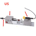 Mini metal woodworking lathe with carving knives on workbench