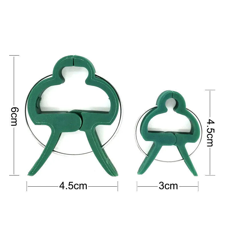 Green plastic plant fixing clips, 10 large and 10 small, for securing climbing plants like tomatoes and cucumbers.