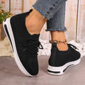Women's red fly-knit lace-up sneakers with a low-top round-toe design on a white background.