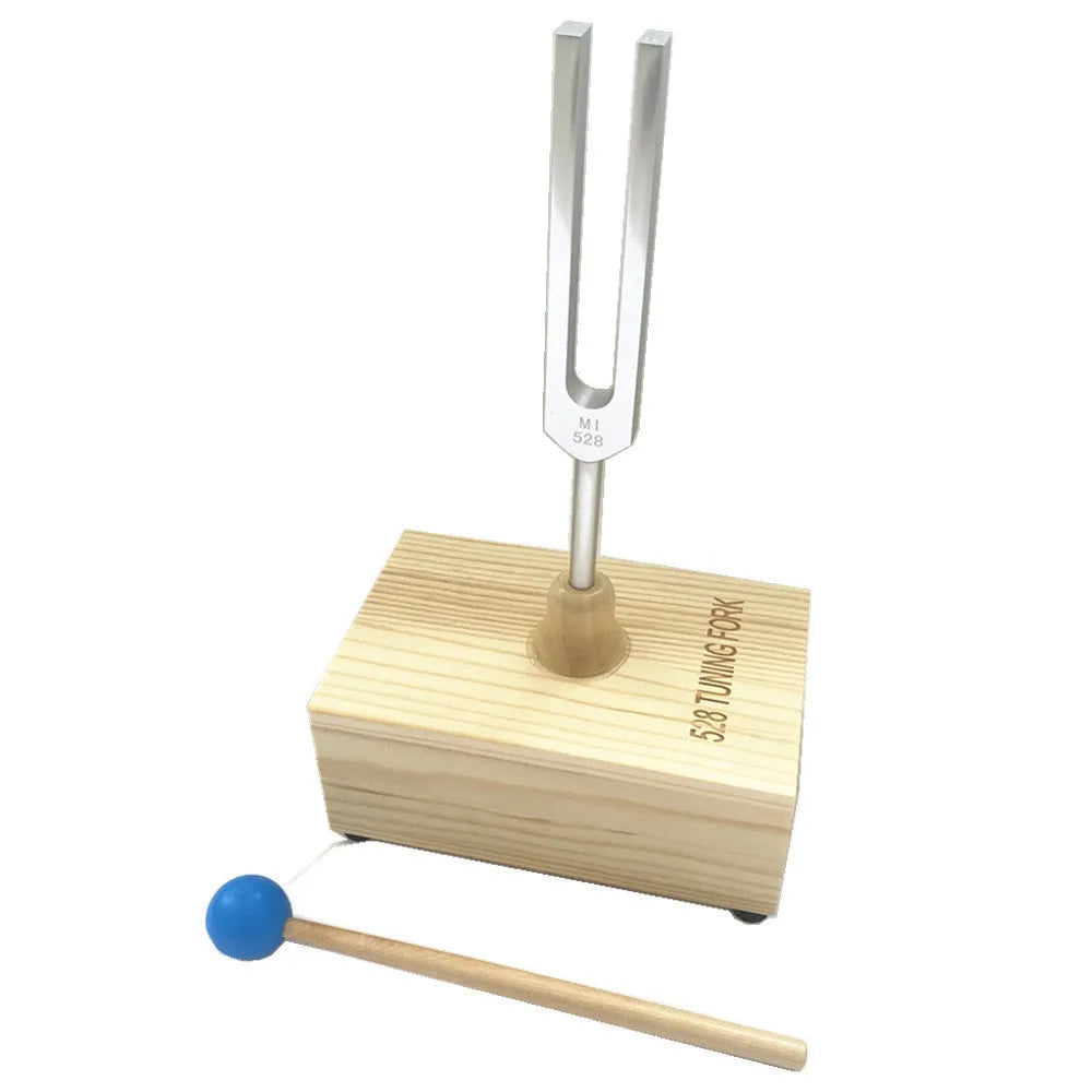 432Hz aluminium tuning fork and small speaker set on kraft paper packaging