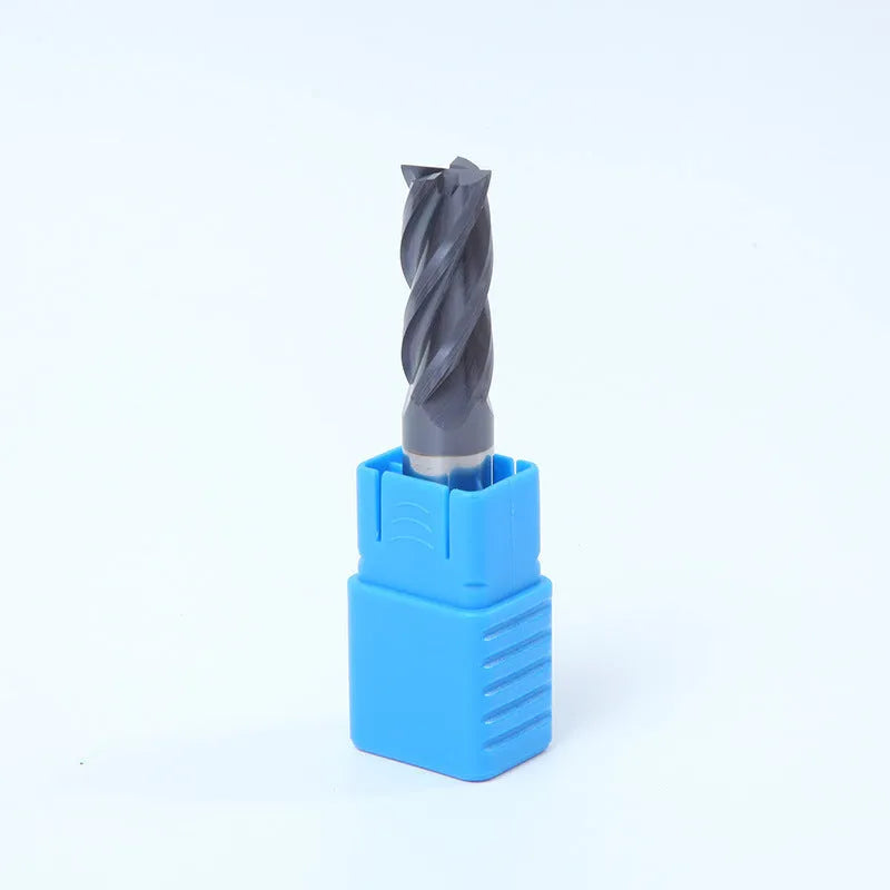 Set of straight shank carbide milling cutters with spiral edges on a workshop bench.