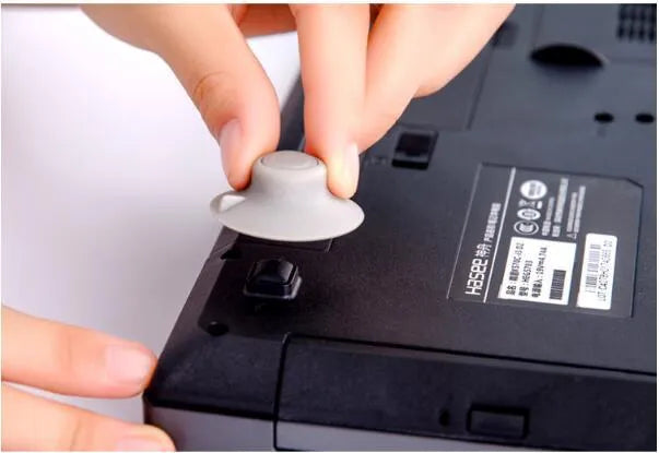 Set of four grey durable plastic laptop cooling pads, two large and two small, on a flat surface.