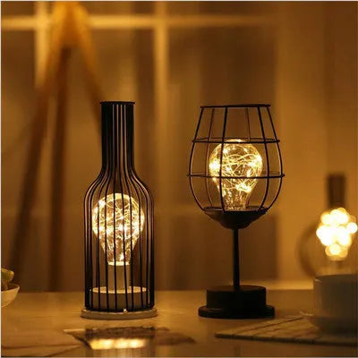 Minimalist hollow iron table lamp in wine bottle design with warm white LED lighting