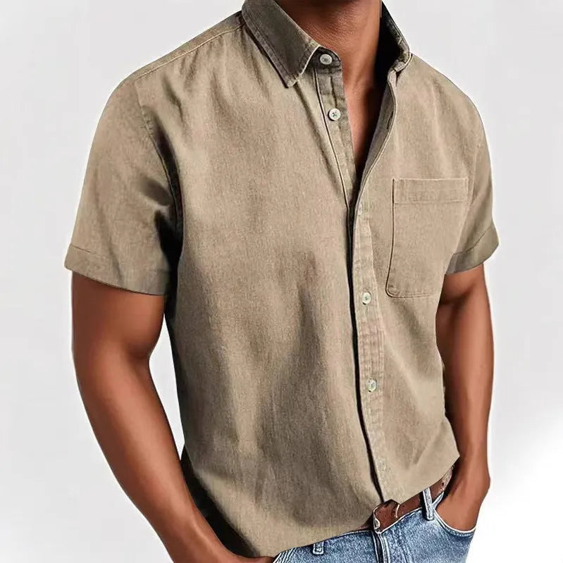 Man wearing a loose grey short sleeve single-breasted cardigan-style shirt.