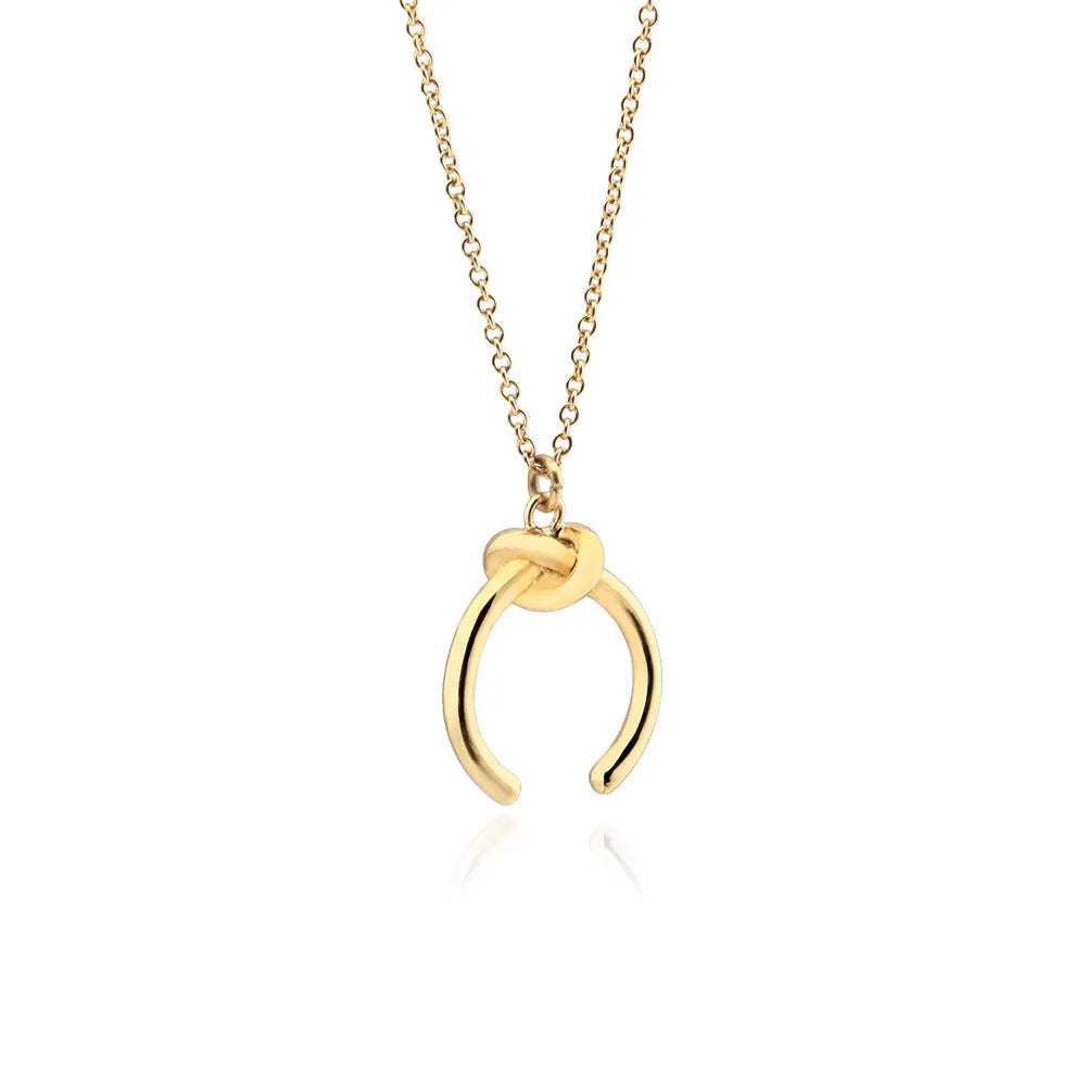 Gold geometric pendant necklace on a cross chain with vintage style.