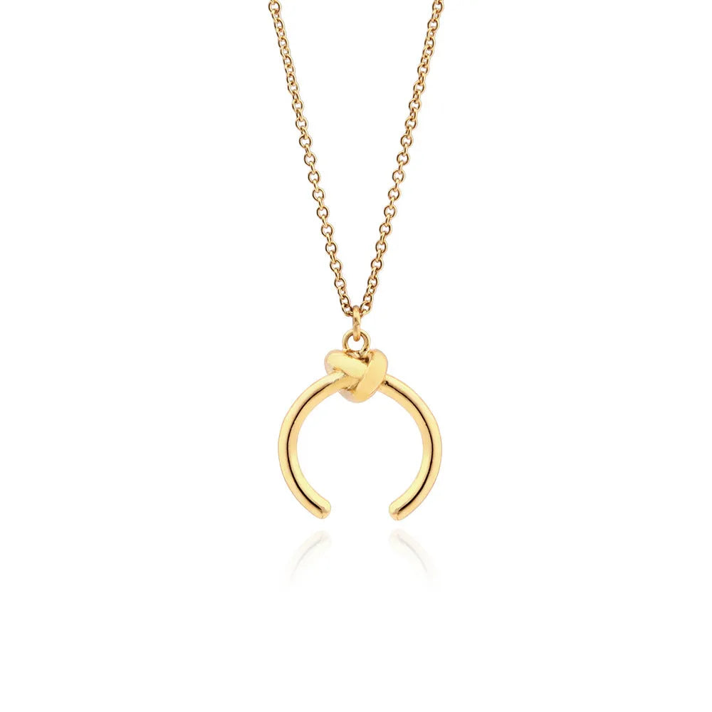 Gold geometric pendant necklace on a cross chain with vintage style.