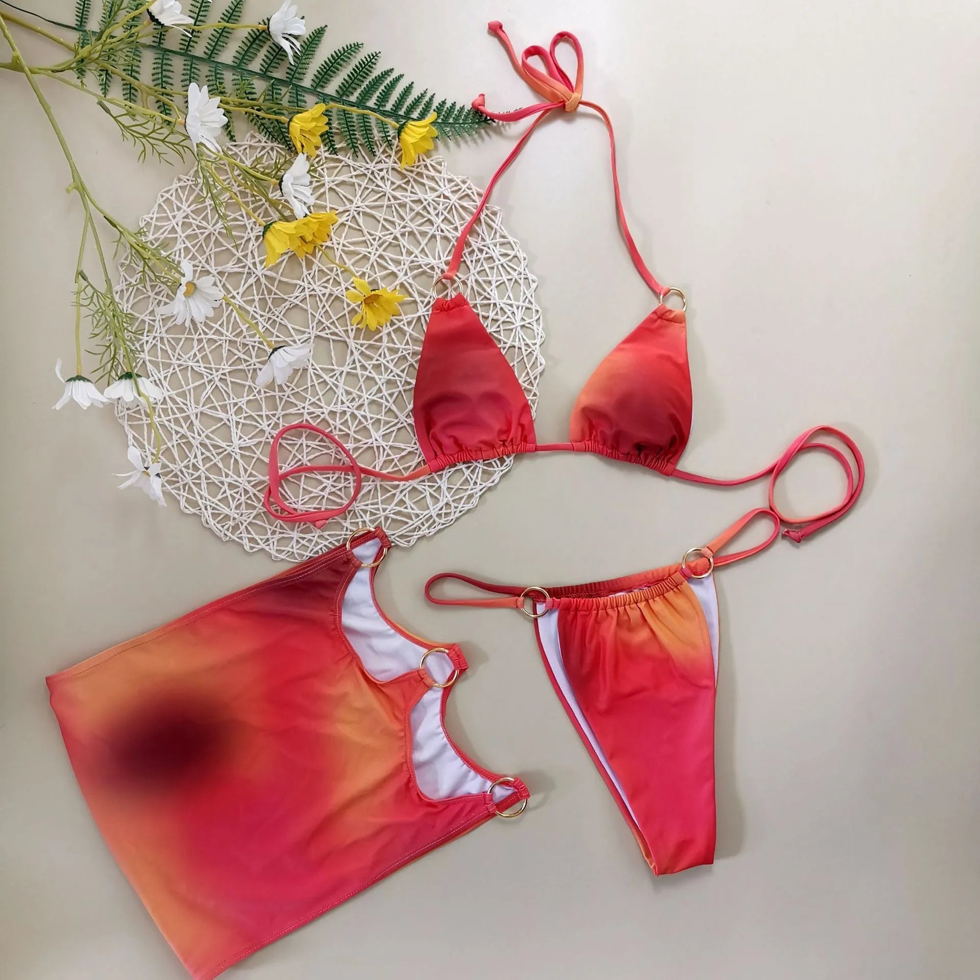 Tie-dye pattern three-piece swimsuit set with halter top, high-leg pants, and matching skirt