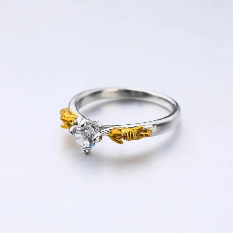 Black gold copper crown crystal ring for cosplay on a grey background.