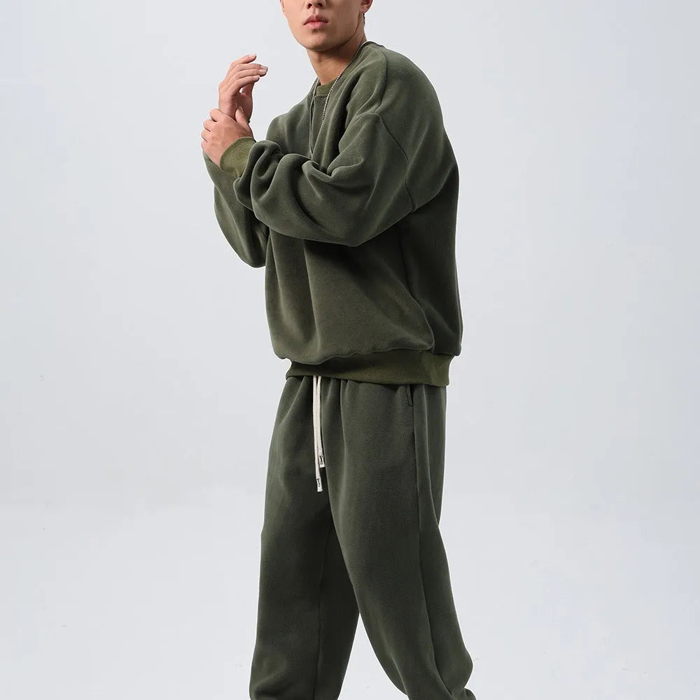 Men's black polar fleece sports suit with long sleeve crew neck coat and loose fit trousers.