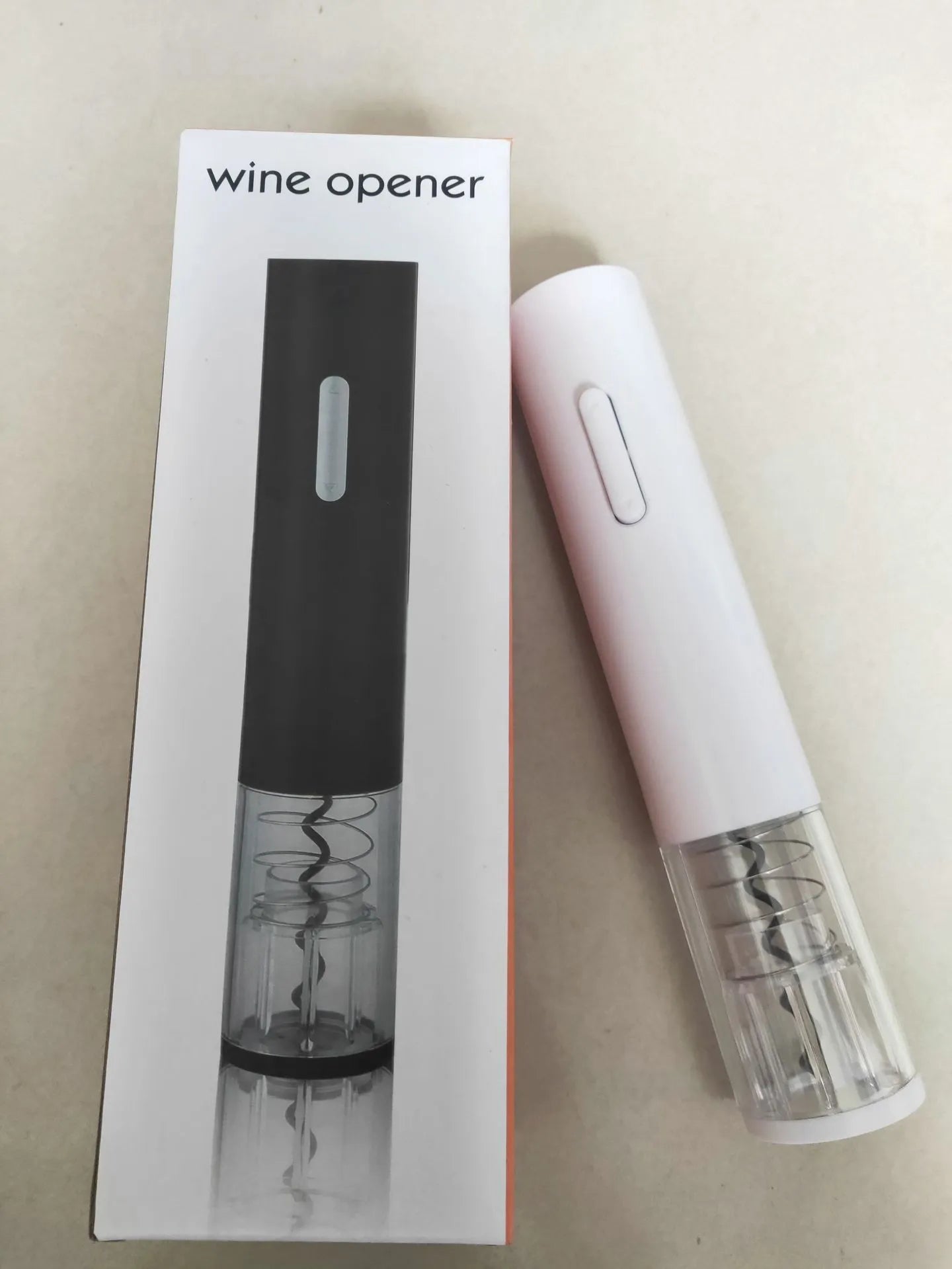 Black automatic electric wine bottle opener with integrated foil cutter on a countertop