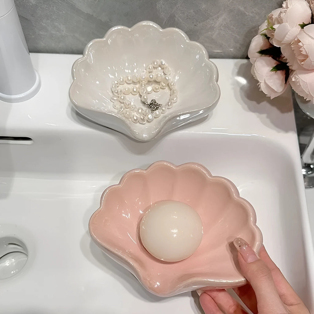 White and pink plastic shell-shaped soap dish for bathroom use