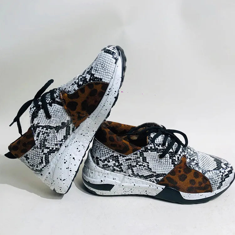 Women's casual flat sneakers in leopard print with suede upper and a low wedge heel.
