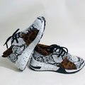 Women's casual flat sneakers in leopard print with suede upper and a low wedge heel.