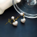 Korean style heart-shaped women's stud earrings with pearl design and alloy construction