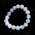 Natural blue moonlight round bead bracelet made from polished moonstone stones on a wrist.