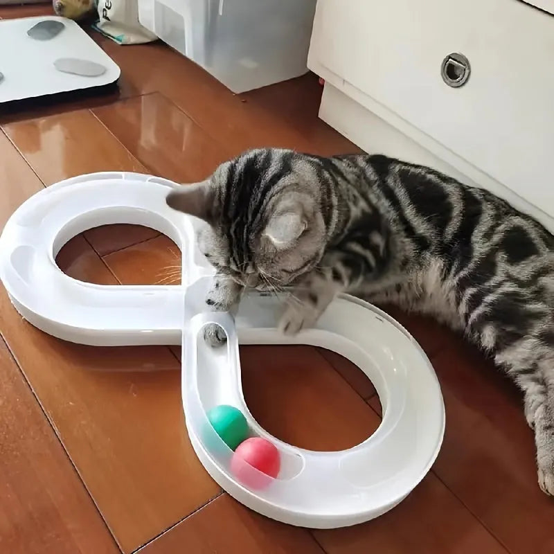 Blue and white plastic cat turntable track ball toy with a teasing stick on a flat surface.