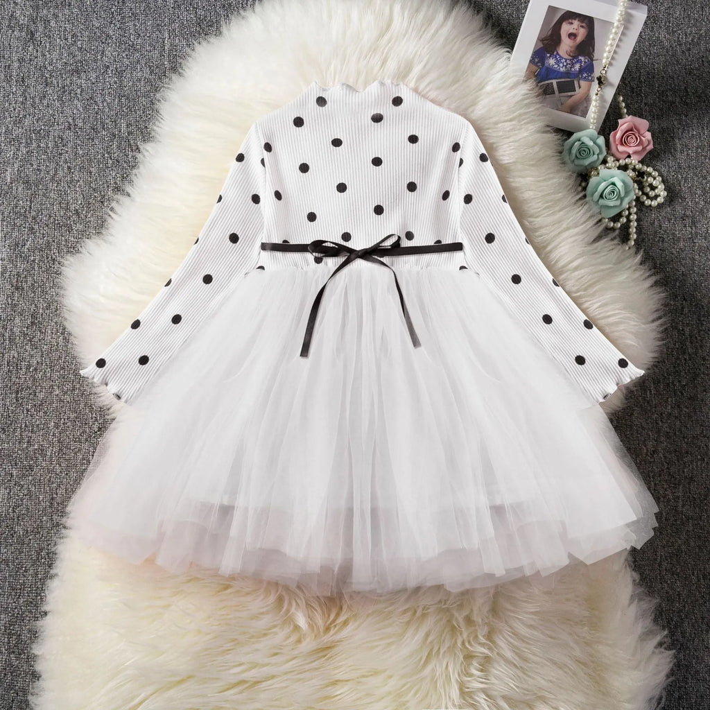 Baby girl wearing a long sleeve black tutu dress with lace detail, suitable for a party or casual wear.