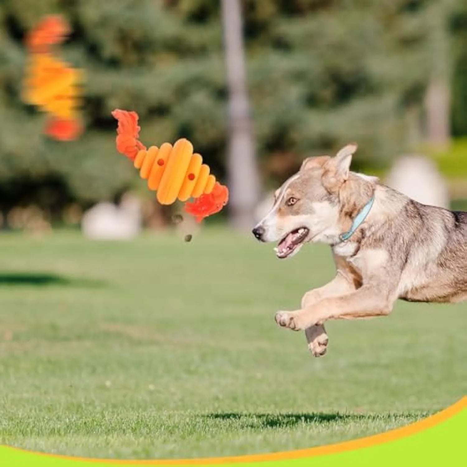 Green and yellow oval dog ball with knotted rope, a slow-leak food dispenser chew toy.