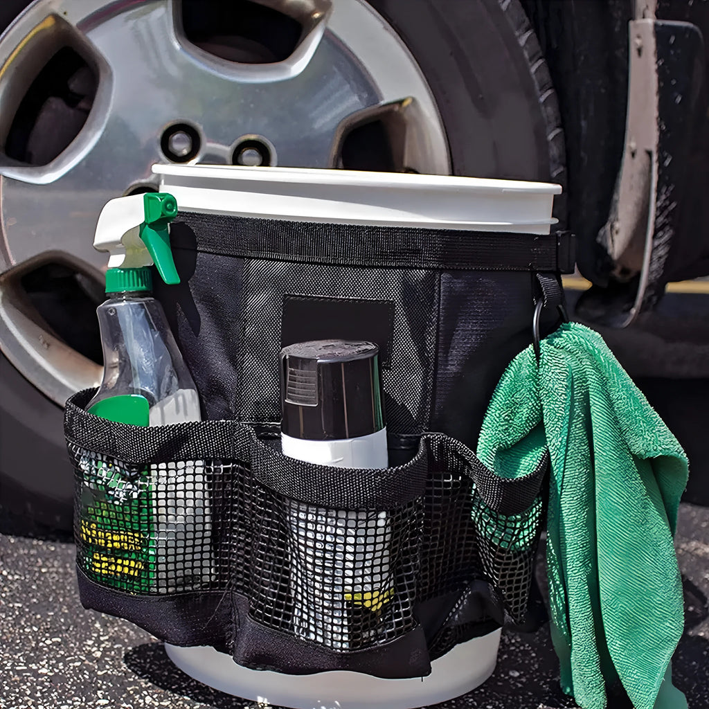 Black cylindrical polyester storage bag hanging from the rim of a 5-gallon barrel.