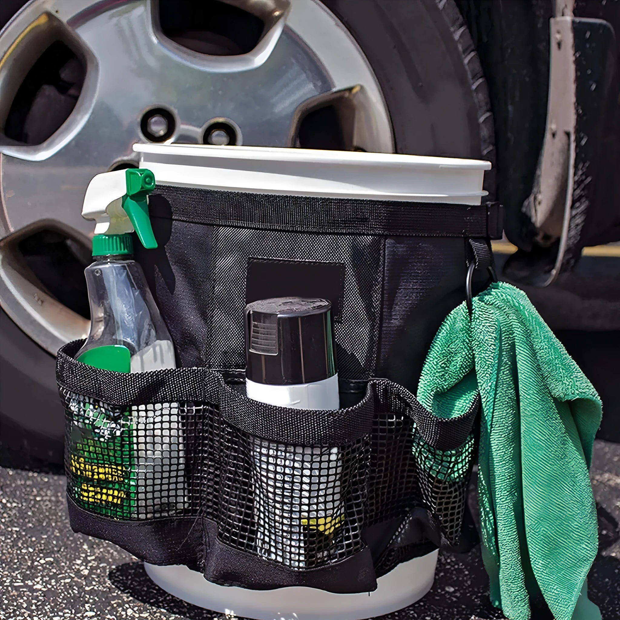 Black cylindrical polyester storage bag hanging from the rim of a 5-gallon barrel.
