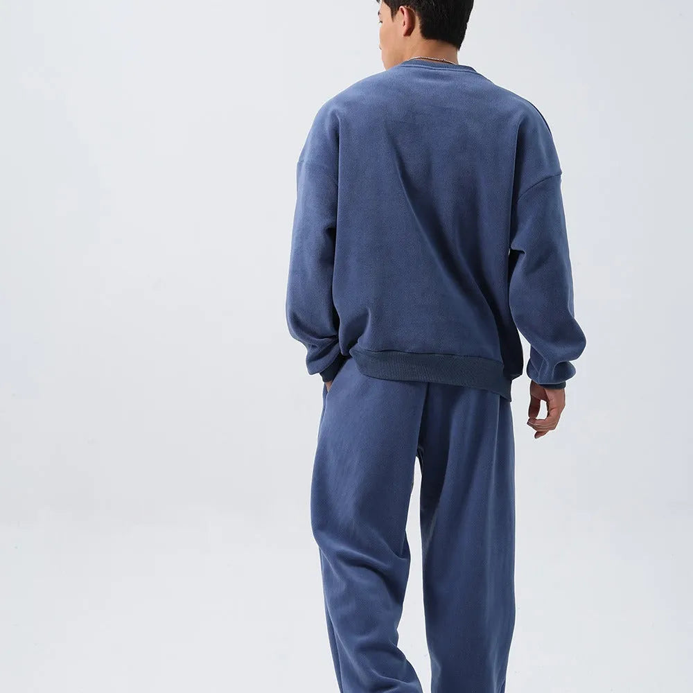 Men's black polar fleece sports suit with long sleeve crew neck coat and loose fit trousers.