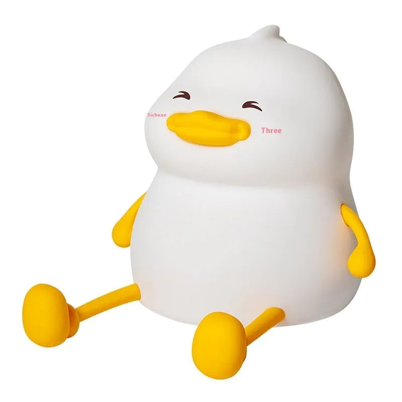 Chubby rechargeable touch-control night light with soft silicone phone holder base.