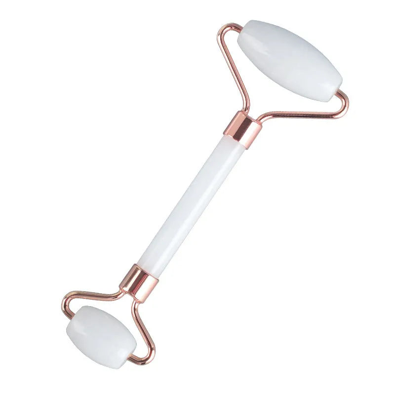 White jade facial roller and matching massage board set on a flat surface.