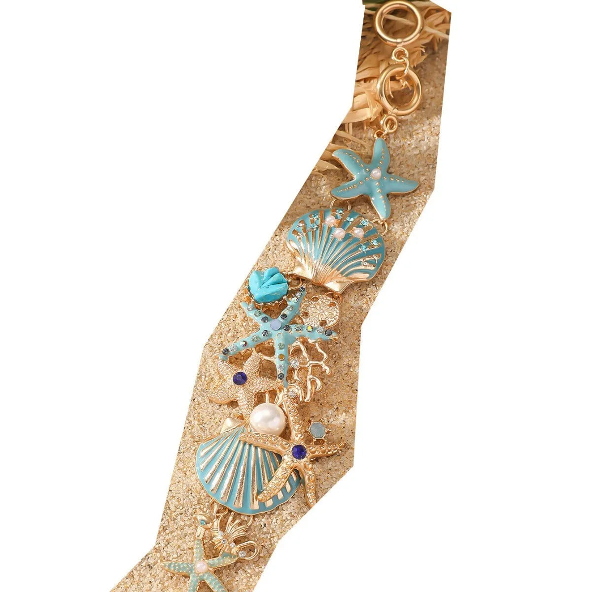 Close-up of a women's alloy starfish rhinestone bracelet in turquoise colour.