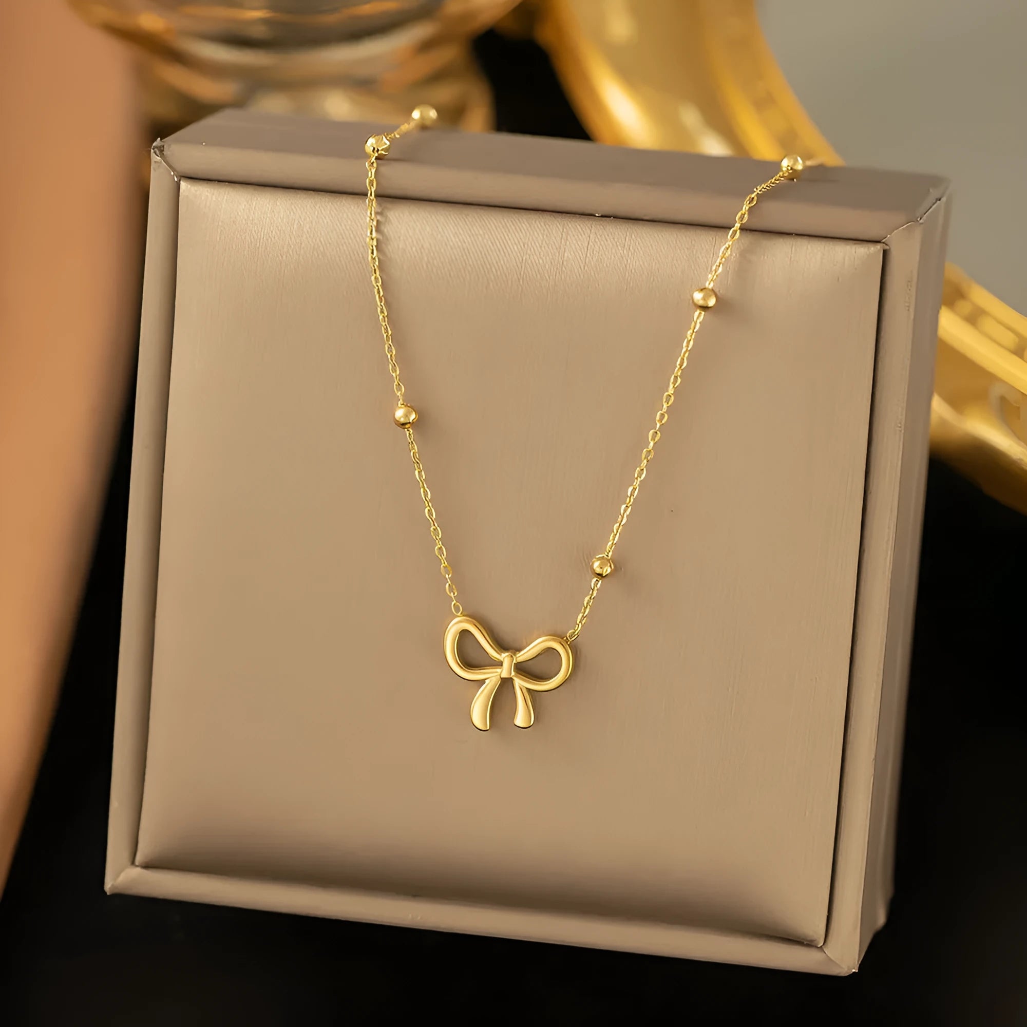 Gold bow necklace for women with cross chain design and adjustable length