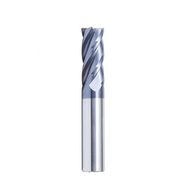 Set of straight shank carbide milling cutters with spiral edges on a workshop bench.