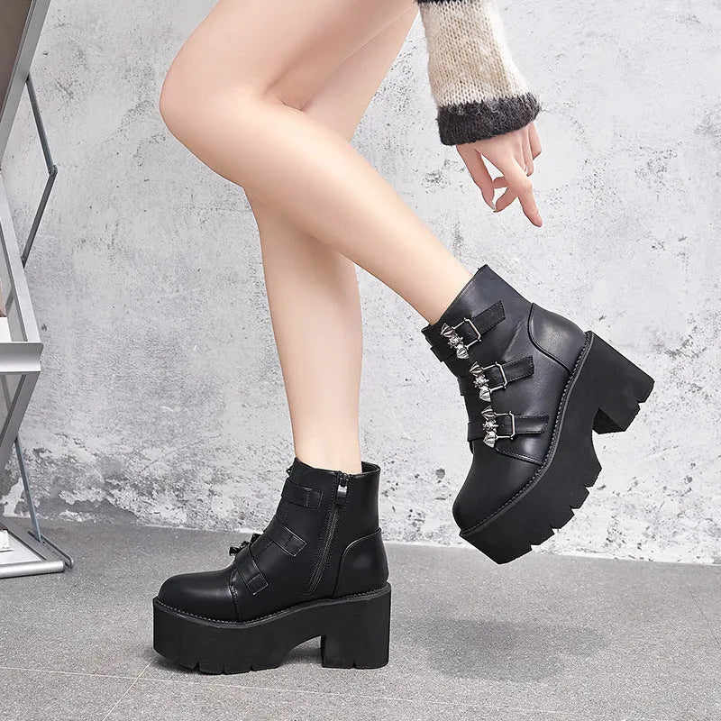 Black women's punk ankle boots with bat buckle, side zipper, thick heel, and round toe.