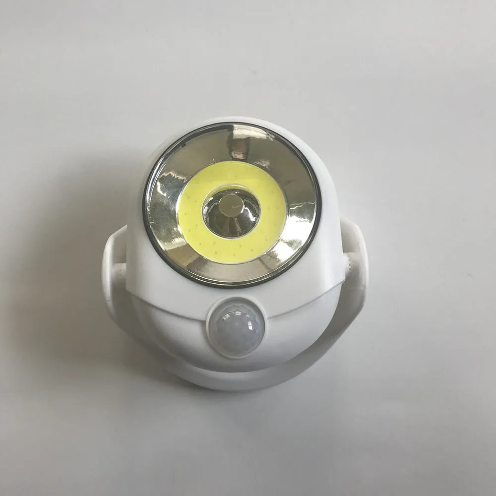 White Atomic Angel induction light unit showing compact design