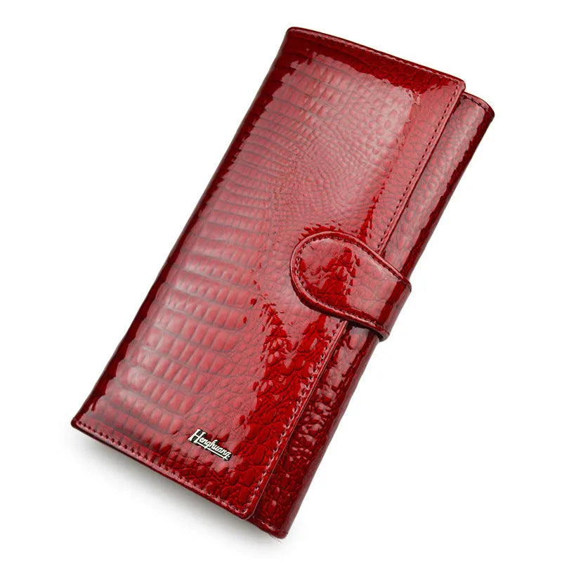Women's patent leather coin purse with crocodile pattern in wine red colour showing pigskin lining