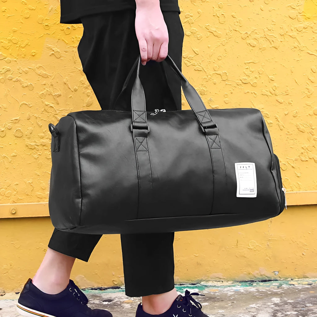Large black waterproof sports gym bag with separate side shoe compartments and a diagonal carry strap.
