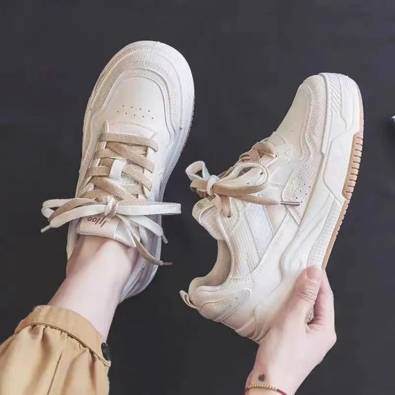 Low-top sneakers with rubber soles in beige and pink colour options showing height-increasing design